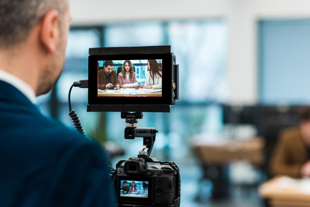 Professional photographer shooting a business meeting in an office